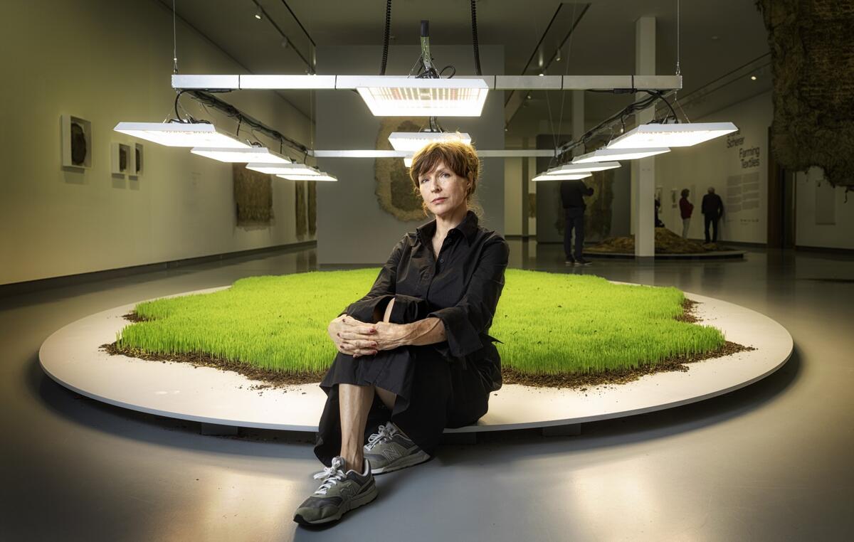 Diana Scherer sitting in front of one of her works