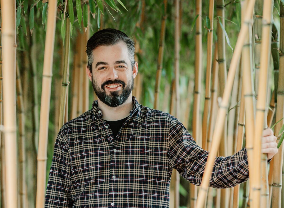 Photo of Norbert surrounded by bamboo