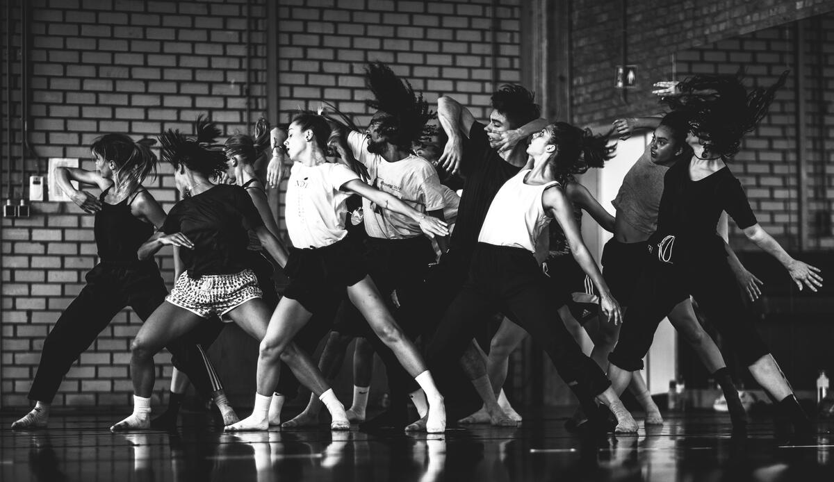 Black-and-white photograph of people dancing in a dance studio