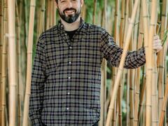 Photo of Norbert surrounded by bamboo