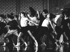 Black-and-white photograph of people dancing in a dance studio